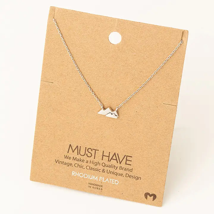 Mini overlapping mountains pendant necklace silver chain and background mountain